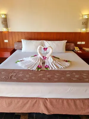 a bed with a swan made out of flowers at Karona Resort & Spa - SHA Extra Plus in Karon Beach