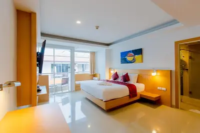 a bedroom with a bed and a television in it at Aspery Hotel in Patong Beach