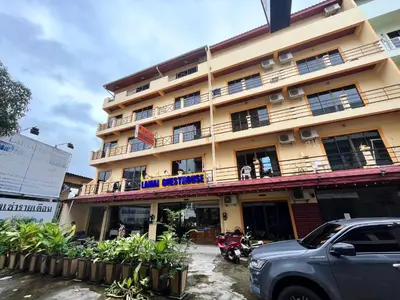 a building with a car parked in front of it at Patong Lamai Residence in Patong Beach
