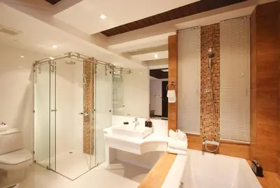 a bathroom with a tub and a sink and a shower at Rayaburi Hotel, Patong in Patong Beach