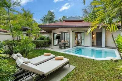 a backyard with a pool and a villa at Dewa Phuket Resort & Villas, Nai Yang Beach in Nai Yang Beach
