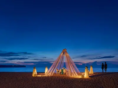 a tent on the beach at night at Dusit Thani Laguna Phuket in Bang Tao Beach