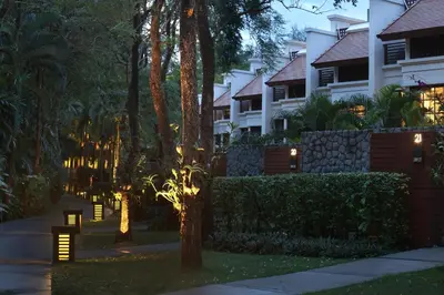 a walkway in front of a building with lights at Dusit Thani Laguna Phuket in Bang Tao Beach
