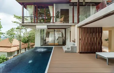 an external view of a house with a swimming pool at Villa Zolitude Resort & Spa - SHA Extra Plus in Chalong