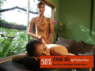 a woman laying on a bed in front of a mirror at Sino House Phuket Hotel - SHA Plus in Phuket Town