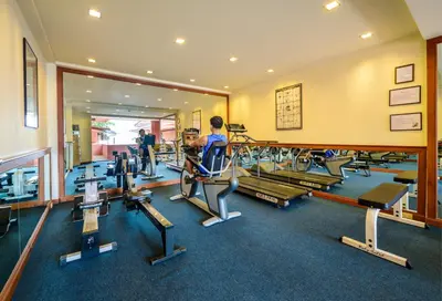a gym with a bunch of tread machines in it at Seaview Patong Hotel - SHA Plus in Patong Beach