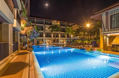 a swimming pool in a hotel at night at Ananta Burin Resort in Ao Nang Beach