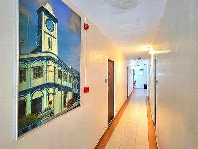 a hallway with a painting of a clock tower on the wall at The Album Loft in Patong Beach
