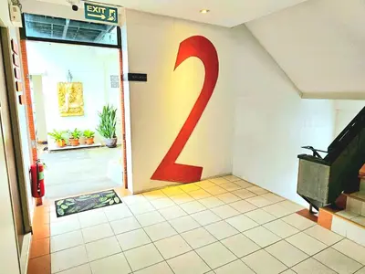 a door with a number painted on the wall at The Album Loft in Patong Beach