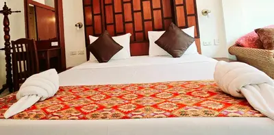 a hotel room with two beds with towels on them at The Album Loft in Patong Beach