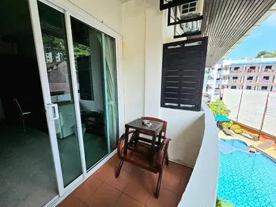 a small table on the balcony of a apartment at The Album Loft in Patong Beach