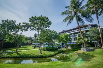 a view of the resort with a pond and palm trees at Holiday Ao Nang Beach Resort, Krabi in Ao Nang Beach