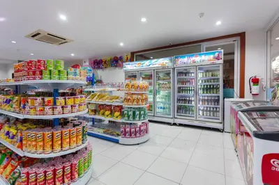 a grocery store aisle with drinks and soda at Baumancasa Beach Resort in Karon Beach