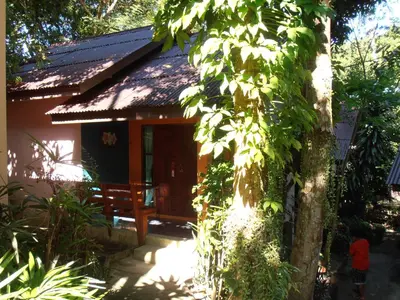 a small house with a tree in front of it at Aonang Green Park Bungalow in Ao Nang Beach