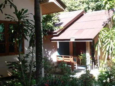 a house with a porch with a roof at Aonang Green Park Bungalow in Ao Nang Beach