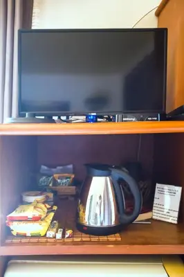 a tea kettle sitting on a shelf next to a tv at Klong Muang Sunset House in Klong Muang Beach