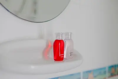 a red bottle is sitting on a shelf at Klong Muang Sunset House in Klong Muang Beach