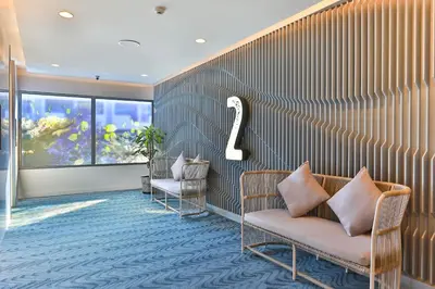 a waiting room with two chairs and a number two at Hotel Clover Patong Phuket - SHA Plus in Patong Beach