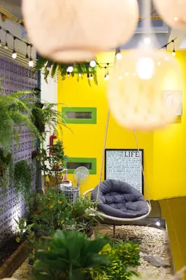 a yellow room with a blue bean bag chair at Aekkeko hostel in Phuket Town