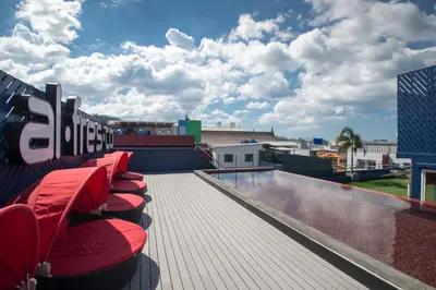 a row of red chairs sitting on top of a roof at Alfresco Phuket Hotel in Patong Beach