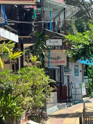 a street with trees and plants in front of a building at Bang sit Guest House in Phi Phi Don