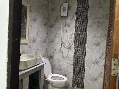 a bathroom with a toilet and a sink and a shower at Bang sit Guest House in Phi Phi Don