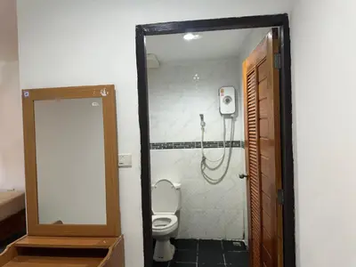 a bathroom with a toilet and a mirror at Bang sit Guest House in Phi Phi Don