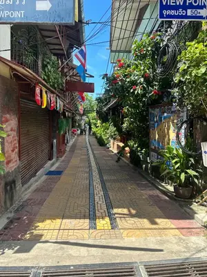 a street in a city with a train track at Bang sit Guest House in Phi Phi Don
