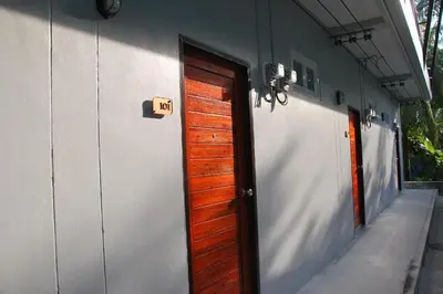 a house with a door with a sign that reads exit at Snooze Inn Phuket - Free Shuttle to Bang Rong Pier in Ban Pa Khlok