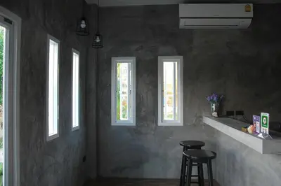 a kitchen with three windows and two bar stools at Snooze Inn Phuket - Free Shuttle to Bang Rong Pier in Ban Pa Khlok