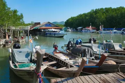 a group of boats are docked at a dock at Snooze Inn Phuket - Free Shuttle to Bang Rong Pier in Ban Pa Khlok