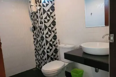 a bathroom with a toilet and a sink at Snooze Inn Phuket - Free Shuttle to Bang Rong Pier in Ban Pa Khlok