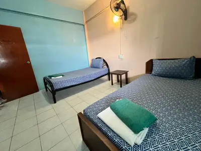 a room with two beds and a couch and a table at J Mansion in Ao Nang Beach