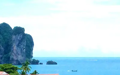 a view of the ocean with a boat in the water at J Mansion in Ao Nang Beach