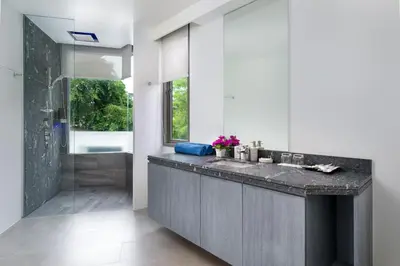 a bathroom with a sink and a shower at Kamala Resotel, SHA Extra Plus in Kamala Beach