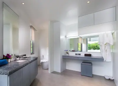 a bathroom with a sink and a toilet and a mirror at Kamala Resotel, SHA Extra Plus in Kamala Beach