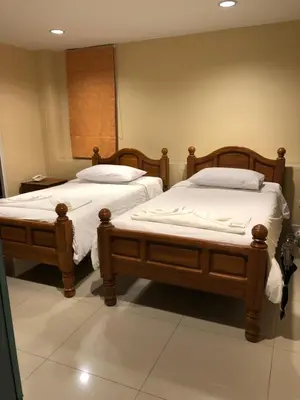 two twin beds in a room withermottermott at Naithon Beach Residence in Nai Thon Beach