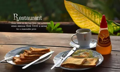 a table with a plate of toast and a cup of coffee at Tha Khao Bay View Bungalow in Ko Yao Noi