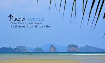 a beach with some rocks in the water and a quote at Tha Khao Bay View Bungalow in Ko Yao Noi