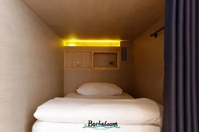 a small room with two beds in it at Borbaboom Phuket Poshtel & Hostel in Phuket Town