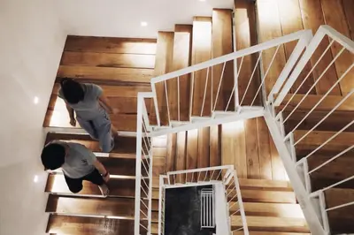 two people walking up the stairs of a house at Borbaboom Phuket Poshtel & Hostel in Phuket Town