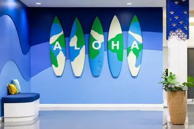 a mural of surfboards on a wall in a room at Amata Patong in Patong Beach