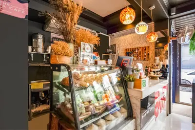 a bakery with a display case filled with food at The Panwa Guesthouse, Phuket in Panwa Beach
