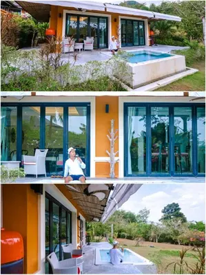 a house with a pool and a person sitting in front of it at Bungalow VILLA Rumba in Ko Yao Noi