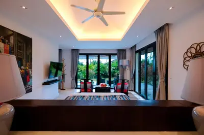 a living room with a ceiling fan at Bungalow VILLA Rumba in Ko Yao Noi