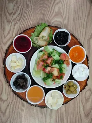 a plate of food with vegetables and other foods on a table at Ruen Buathong Boutique Hotel Patong Beach in Patong Beach