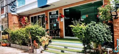 a house with stairs leading to the front door at Ruen Buathong Boutique Hotel Patong Beach in Patong Beach