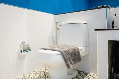 a bathroom with a white toilet with a towel on it at Signature Phuket Resort in Chalong