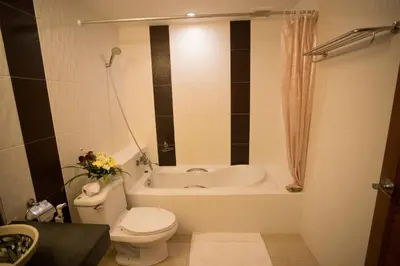 a bathroom with a toilet and a bath tub at Baan Boa Resort in Patong Beach