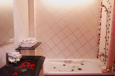 a small bathroom with a tub and a sink at Baan Boa Resort in Patong Beach